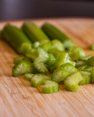 Fresh Organic Chopped Celery Sticks on a Wooden Chopping Board Close-Up