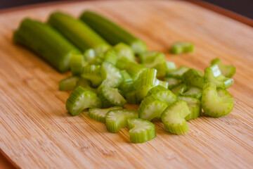 Fresh Organic Chopped Celery Sticks on a Wooden Chopping Board Close-Up