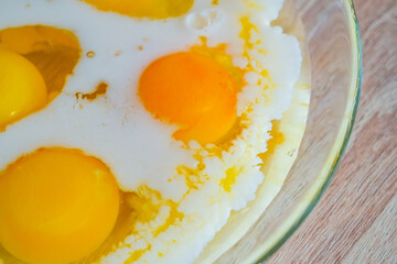 Making an omelet for breakfast. Mixing eggs and lactose free milk.