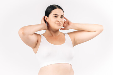 Full-figured young woman posing on a white studio background, exuding confidence and positivity. Perfect for promoting body positivity, fashion, and self-confidence, inspiring self-acceptance.