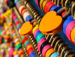 Plenty of colorful love padlocks  (master key) hanging on the rails were locked along the wall at...
