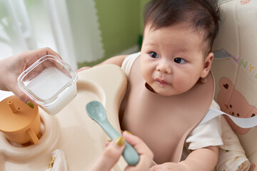 a baby sitting in a high chair