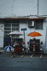 Obraz premium A Street view or street scene, road, view of cityscape in Georgetown, Penang on 3 July 2024, unesco world heritage site, travel destinations. Life at night time, love rain road, light and traffic.
