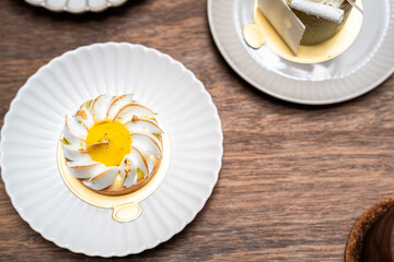 A close up of lemon tart with elegance decoration in a showcase of bakery or coffee shop, concept of sweet and dessert, juicy and freshness, delicious cake, modern and fancy decoration style