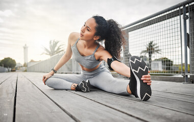 Fototapeta premium Woman, legs and stretching outdoor for exercise, running and cardio fitness in morning with flexible. Athlete, muscle and warm up on bridge for health, training and workout with physical activity