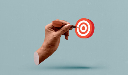 Hand holding a dart aiming at the target - business targeting, aiming. Art collage digital pop...