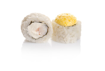 Sliced sushi rolls featuring cream cheese and a yellow topping on a white background with minimalist presentation
