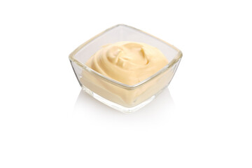 Creamy mayonnaise served in a clear glass bowl on a white surface in a simple and elegant presentation for culinary use