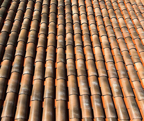 View of red tiles on the roof of the house. Close-up.