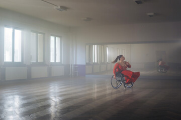 Beautiful dance in a wheelchair of a woman with disability at a dancing studio. Para dance sport. © 24K-Production