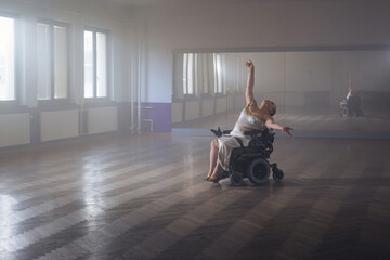 Graceful and elegant movements of a woman with a disability during a solo dance choreography performance on a wheelchair