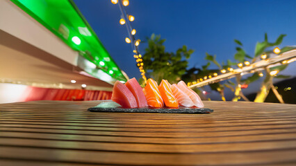 Vibrant Nighttime Sushi Platter Under Festival Lights. Close-up of a sushi selection on a dark plate, set against a bokeh background of sparkling lights and green canopy. Vibrant, appetizing image per