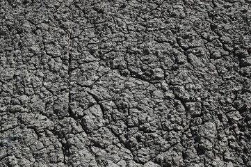 Texture of a black grey gray dry volcanic stone rock background.