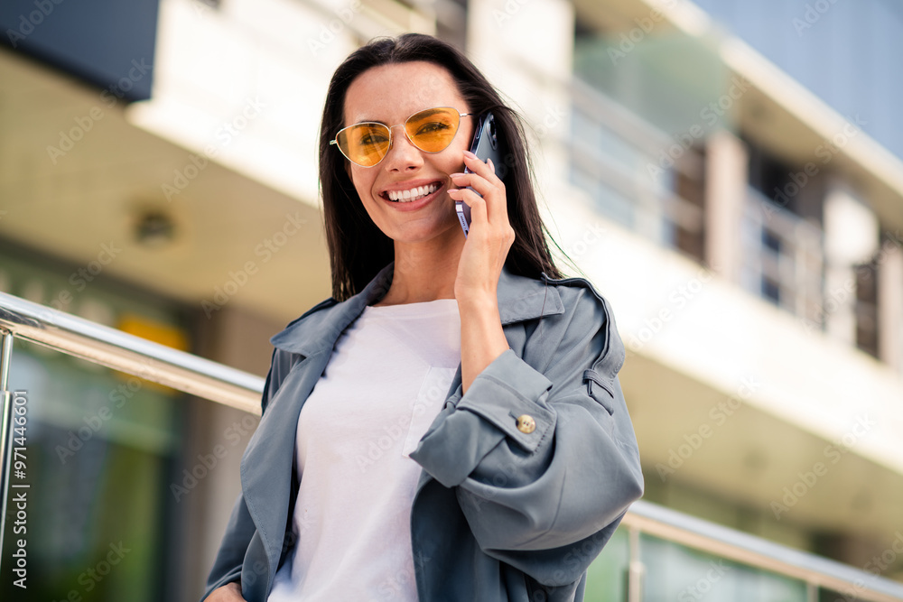 Sticker photo of adorable lovely girl wear grey trench dark glasses smiling talking modern gadget outdoors u