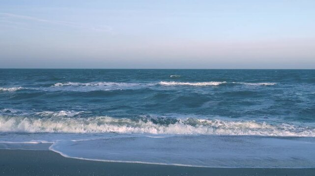 A restless cold winter sea. Waves roll onto the shore. Sea of Azov, Arabatskaya strelka