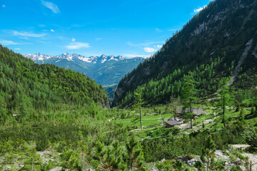 Scenic aerial view of high altitude mountain hut sourrounded by majestic alpine landscape with...