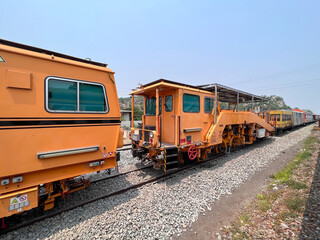 Obraz premium The ballast tamping machines are parked in the site.
