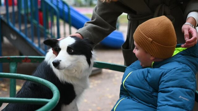 mother with disabled child in disabled Kremlin walk in autumn on the playground on the carousel. High quality FullHD footage