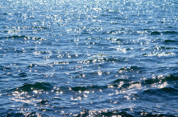 Sea. Abstract view of the blue sea with ripples on the water and white sun glare on a sunny summer day. Nature. Natural background. Concept summer vacation travel tourism