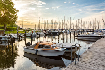 Fototapeta premium Boats in a marina (Langballigau) during beautiful sunset at the Baltic Sea in Northern Germany