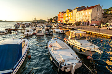 Boats in the marina of Mali on the island of Losinj in the Adriatic Sea in Croatia during beautiful sunset