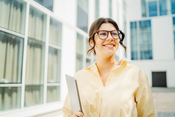 Young successful woman is going to work at modern business building