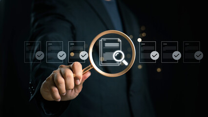 Businessman holding a magnifying glass, showing Audit Document concept,quality assessment...