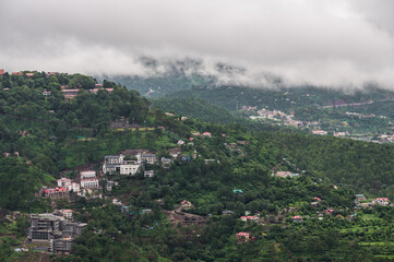 The landscape of Kasauli, Himachal Pradesh. Cloudy day, stunning view of wooden mountains and clouds.