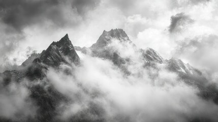 Obraz premium Mountain Peaks Cloaked in Dense Fog and Clouds