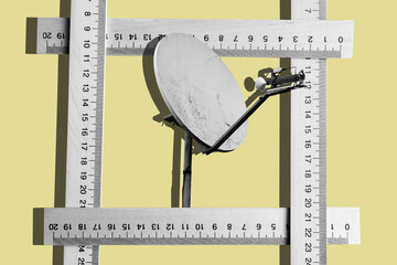 Collage with a dirty sattellite dish and wooden measuring rulers	