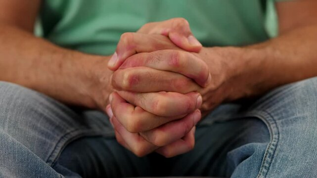 Close-up of hands clenching tightly in anger. The clip focuses on the intense gesture of frustration and anger through the hand movement.