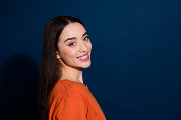 Profile side photo of cheerful lovely cute woman wear orange trendy clothes isolated on dark blue color background