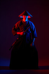 Samurai fighting concept. Samurai silhouette with katana in red light. dark room. shadows. fighter...
