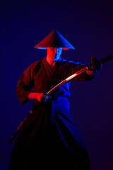 Samurai fighting concept. Samurai silhouette with katana in red light. dark room. shadows. fighter...