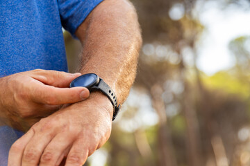 Closeup, person using the smartwatch, outdoors.