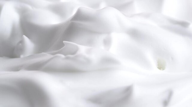 Hair foam mousse, macro. Beauty background. Close up of white cloud of shaving mousse foam.