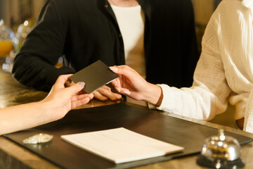 Close-Up of Receiving Room Key at Hotel Reception..