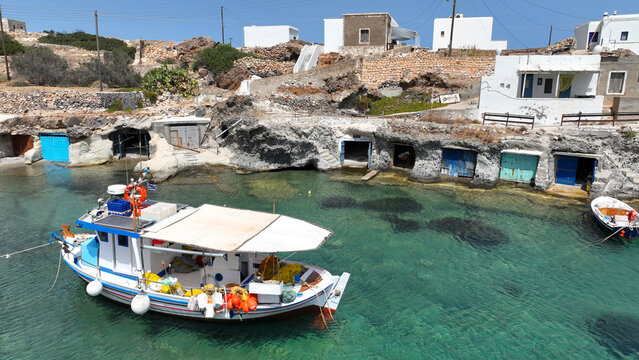 Aerial drone photo of picturesque seaside area and bay of Goupa - Karra with colourful boat houses and elephant rock a perfect place to swim, Kimolos island, Cyclades, Greece