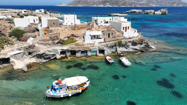 Aerial drone photo of picturesque seaside area and bay of Goupa - Karra with colourful boat houses and elephant rock a perfect place to swim, Kimolos island, Cyclades, Greece