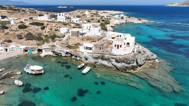 Aerial drone photo of picturesque seaside area and bay of Goupa - Karra with colourful boat houses and elephant rock a perfect place to swim, Kimolos island, Cyclades, Greece