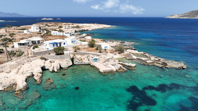 Aerial drone photo of picturesque seaside area and bay of Goupa - Karra with colourful boat houses and elephant rock a perfect place to swim, Kimolos island, Cyclades, Greece