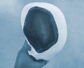 Man holding in hand prototype of human skull from white plastic with individual patient-specific cranial plate grid made of biocompatible titanium printed on 3D printer. Bioengineering implant