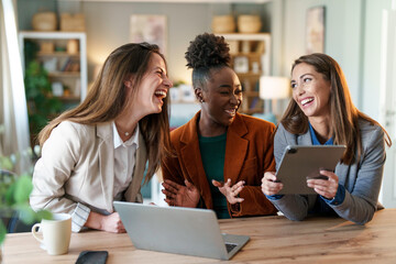 Diverse Businesswomen Engaged in Creative Discussion with Technology