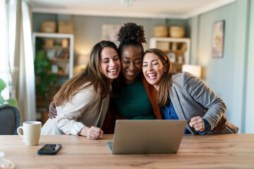 Joyful Diverse Businesswomen Working Together with Laptop