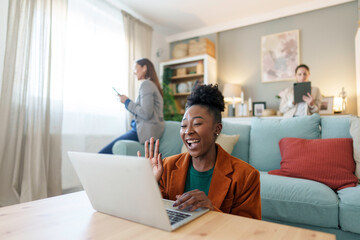 Obraz premium Professional Black Woman Engaging in Video Call in Office Lounge