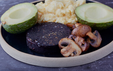 Black pudding with mushrooms ,scrambled eggs and avocados.