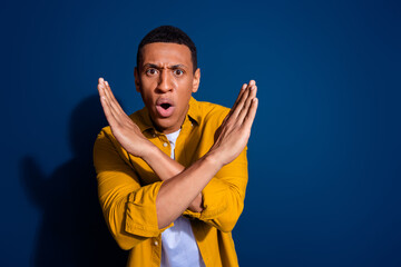 Portrait of nice young man crossed arms wear yellow shirt isolated on dark blue color background