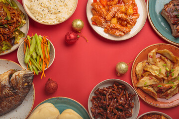 Vibrant chinese new year traditional dishes on a festive red background: kung pal chicken, sweet and sour pork, noodles, dumplings, mapo tofu, fish, rice, fortune cookies. Copy space