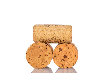Three wine corks, macro, isolated on white background.
