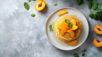 Minimalist flat lay of American pancakes with sliced peaches, placed on a matte grey surface with minimal distractions